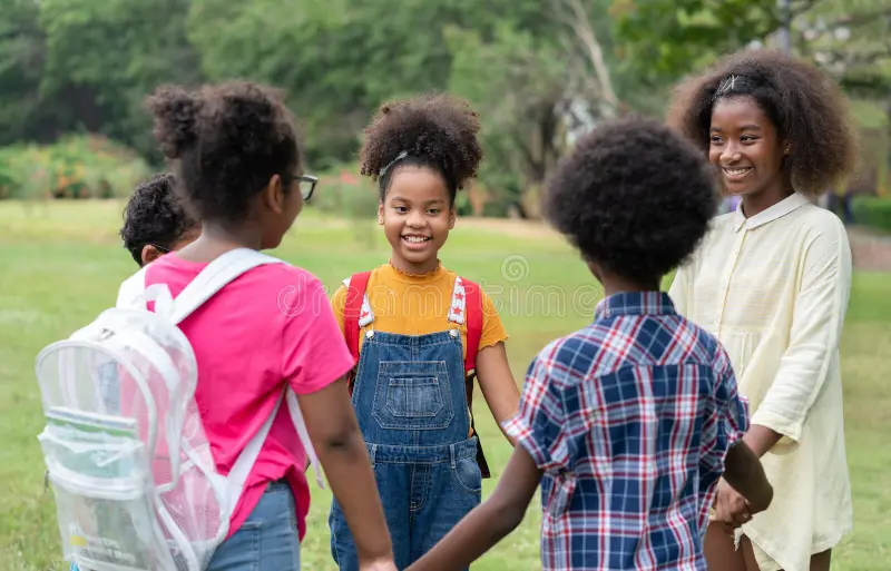 happy-african-american-childrens-standing-holding-hands-together-circle-park-education-outdoor-concept-185718409